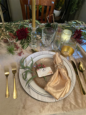 White charger at wedding with gold salad plate and napkin by Rison Design