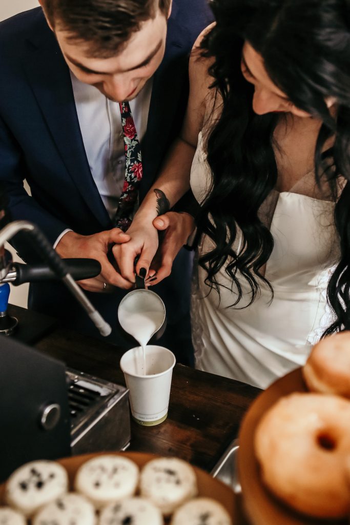 Couple pours lattes with coffee cart for your wedding