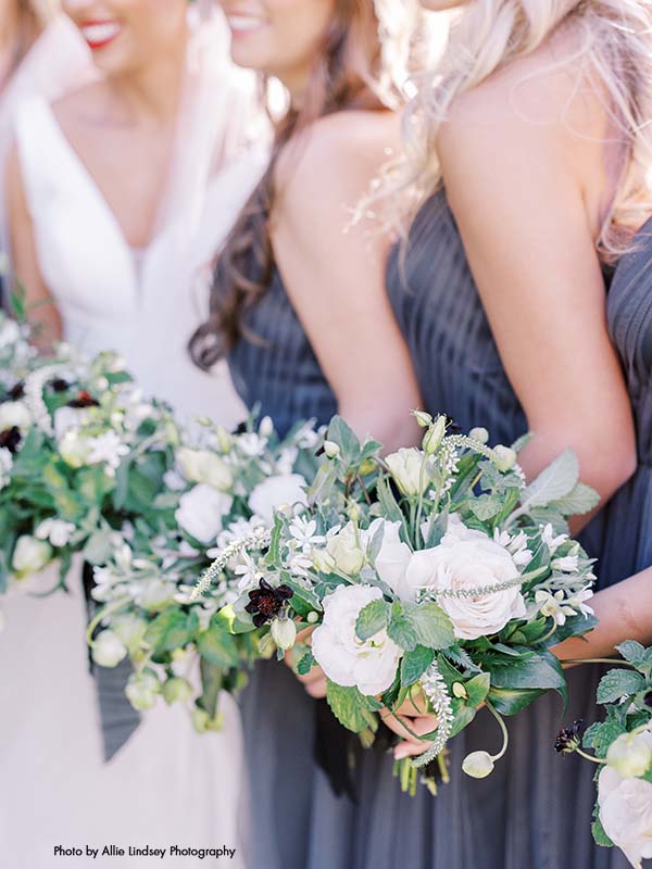 Small bridesmaid bouquets with white flowers and greenery
