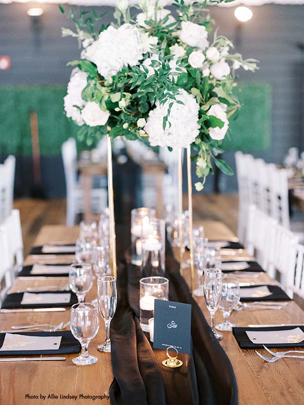 Tall gold centerpiece with white and green floral