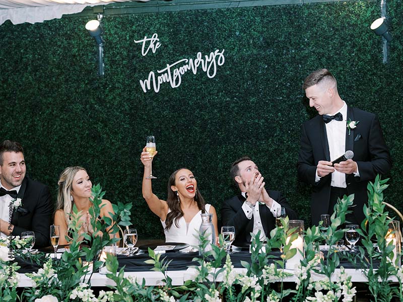 Bride and groom cheers during wedding toasts