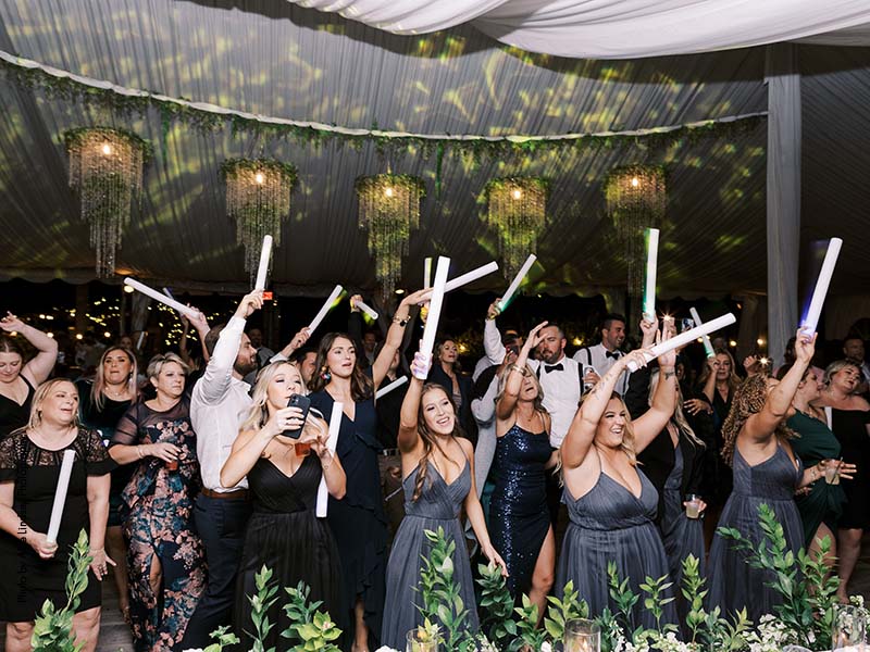 Wedding party dances at outdoor tented reception