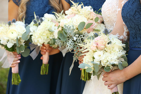 White and blush bridesmaids bouquets by Renning's Floral