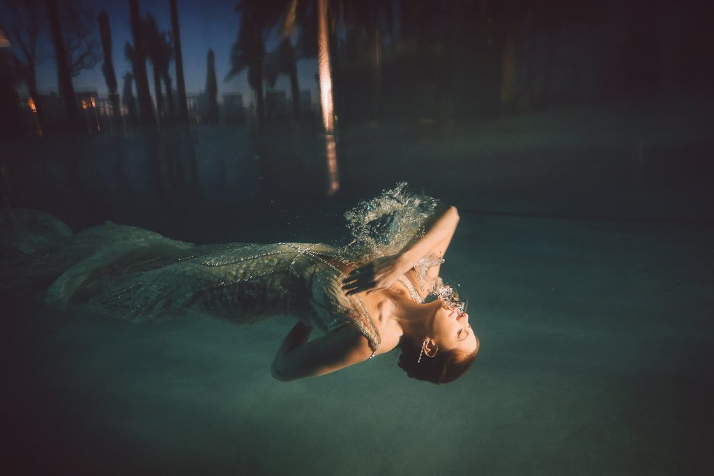 Artistic bridal photo or bride swimming through water