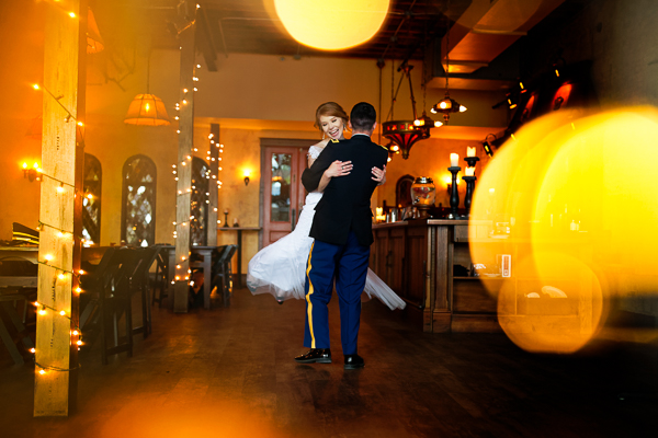 Bride and groom dance in ballroom
