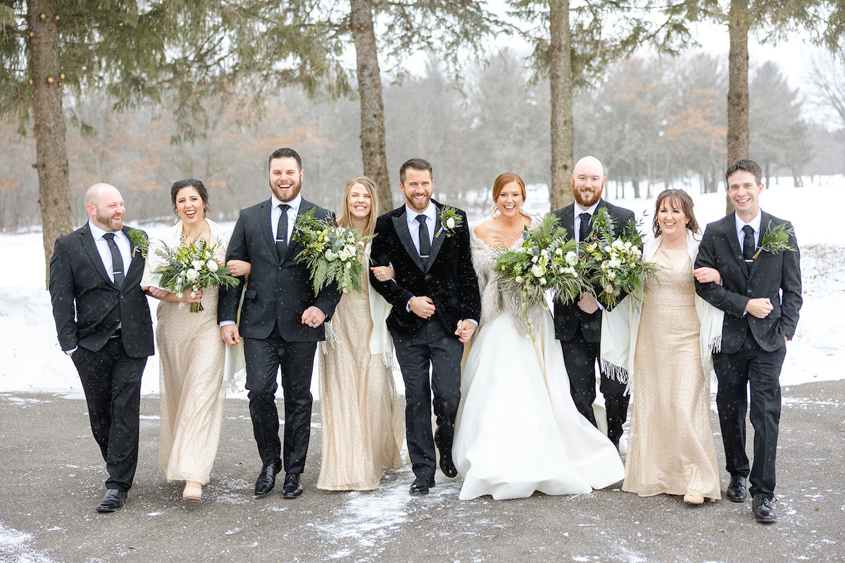 Cozy winter wedding party in black tuxes and gold bridesmaid dresses