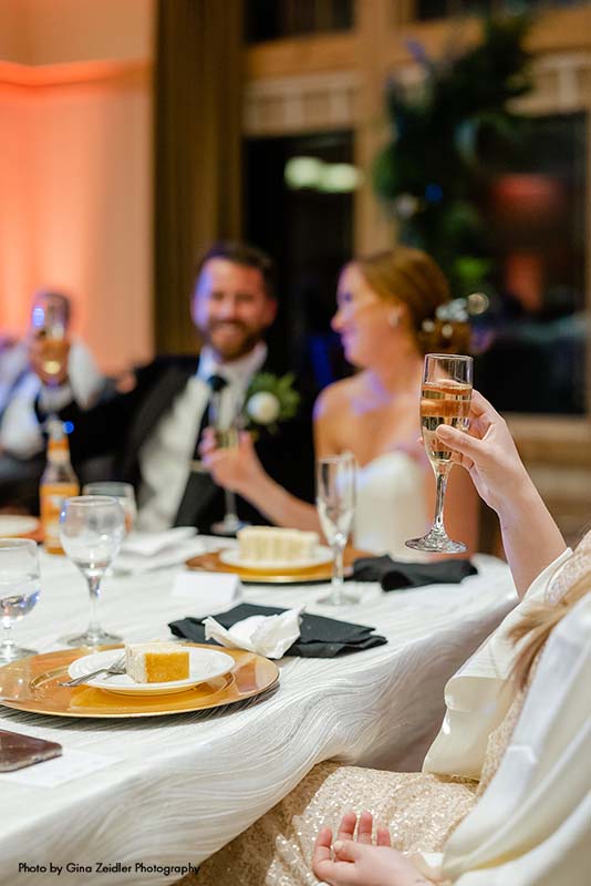 Bride and groom cheers at winter wedding reception