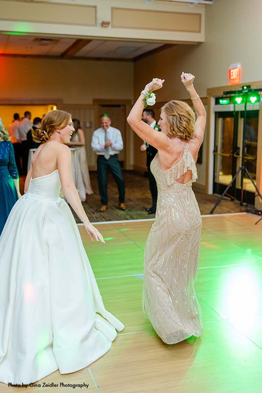 Bride dances with mother at wedding