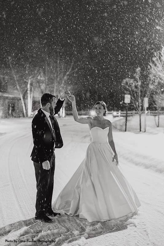 Bride and groom dance in the snow