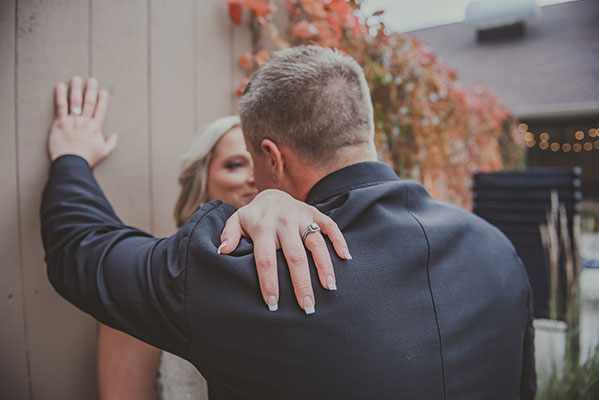 Bride puts hands on groom's shoulder