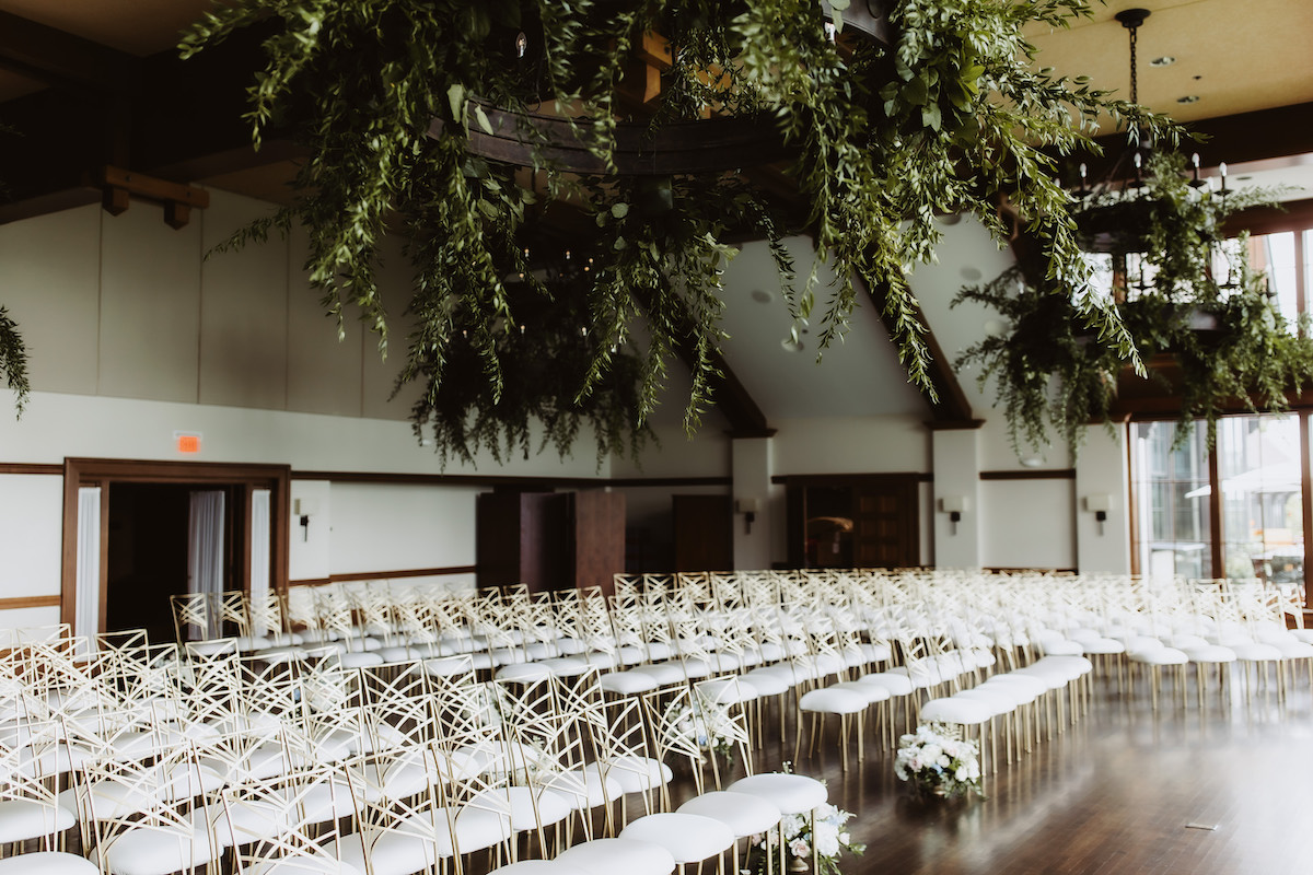 Indoor Grand Garden wedding ceremony with greenery installations