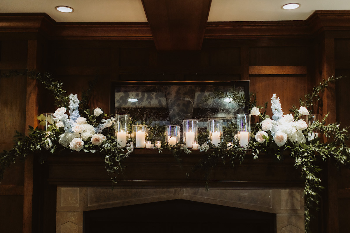 Wedding fireplace decor with flowers and candles
