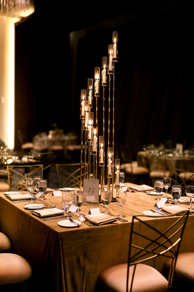 Elegant tall gold taper candle wedding centerpiece