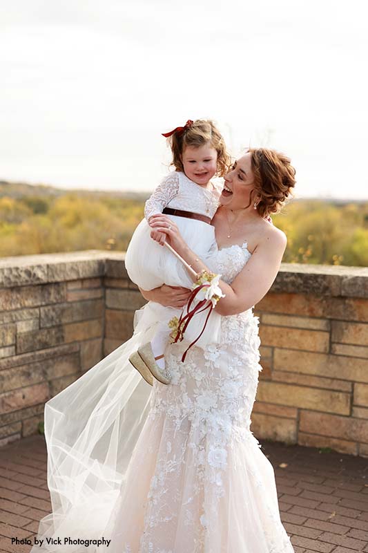 Bride poses with flower girl