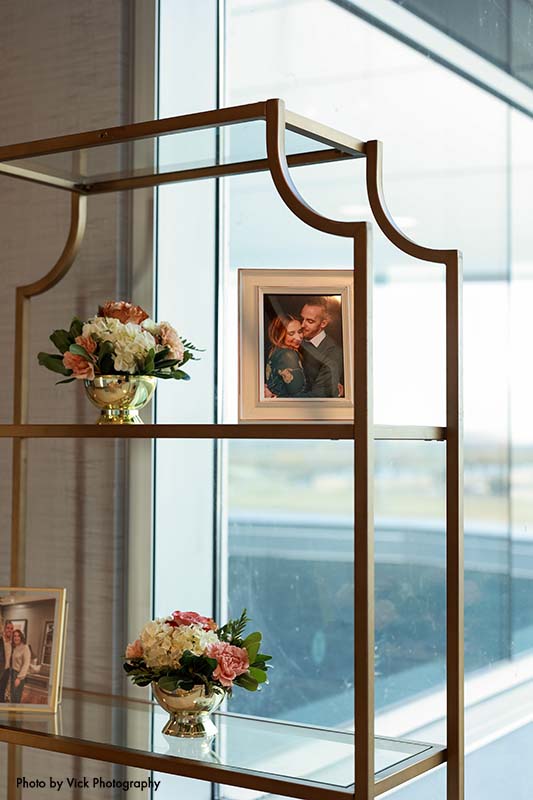 Gold shelves at wedding with photos of couple