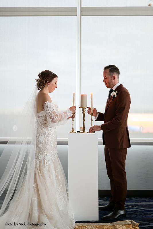 Bride and groom perform unity candle ceremony