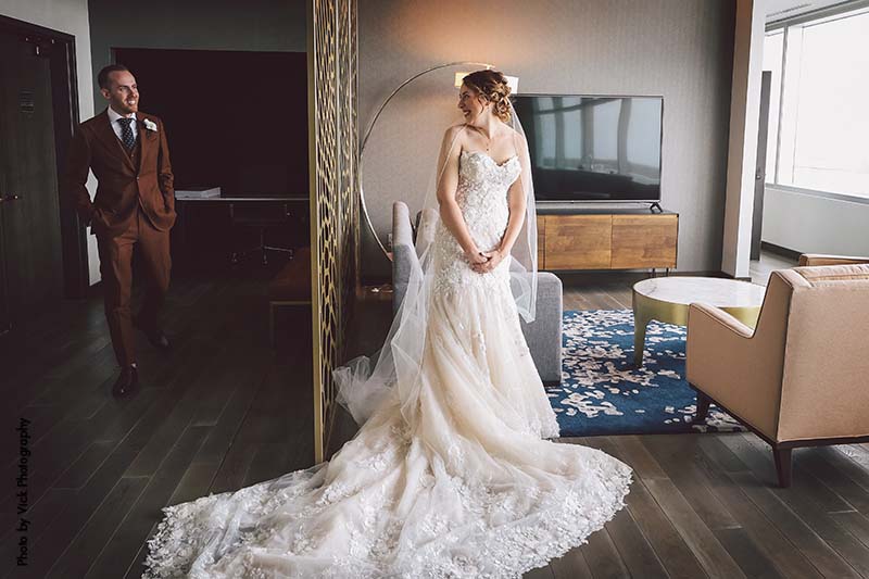 Bride in strapless dress with cathedral train shares first look with groom