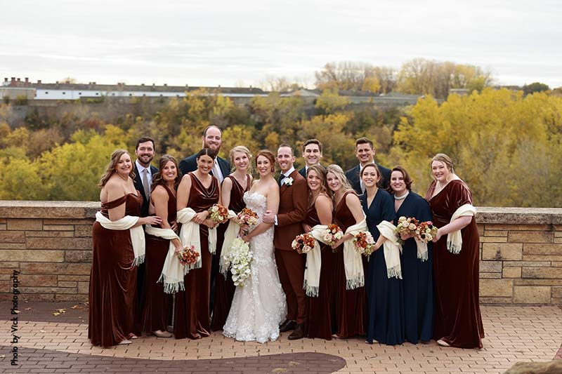 Wedding party poses with couple