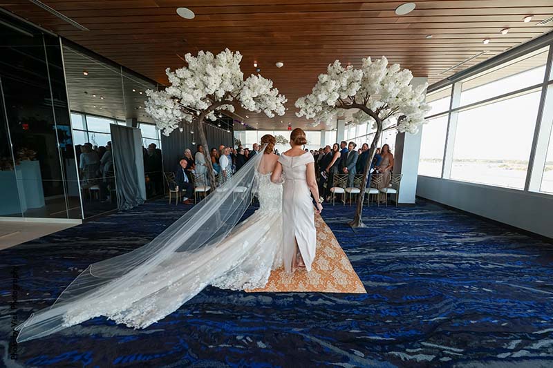 Bride walks down the aisle with mother