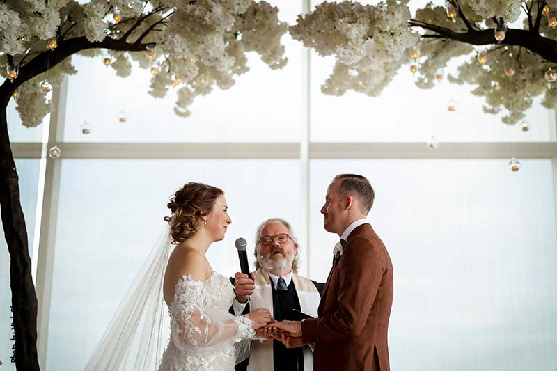 Bride and groom recite vows during fall wedding ceremony