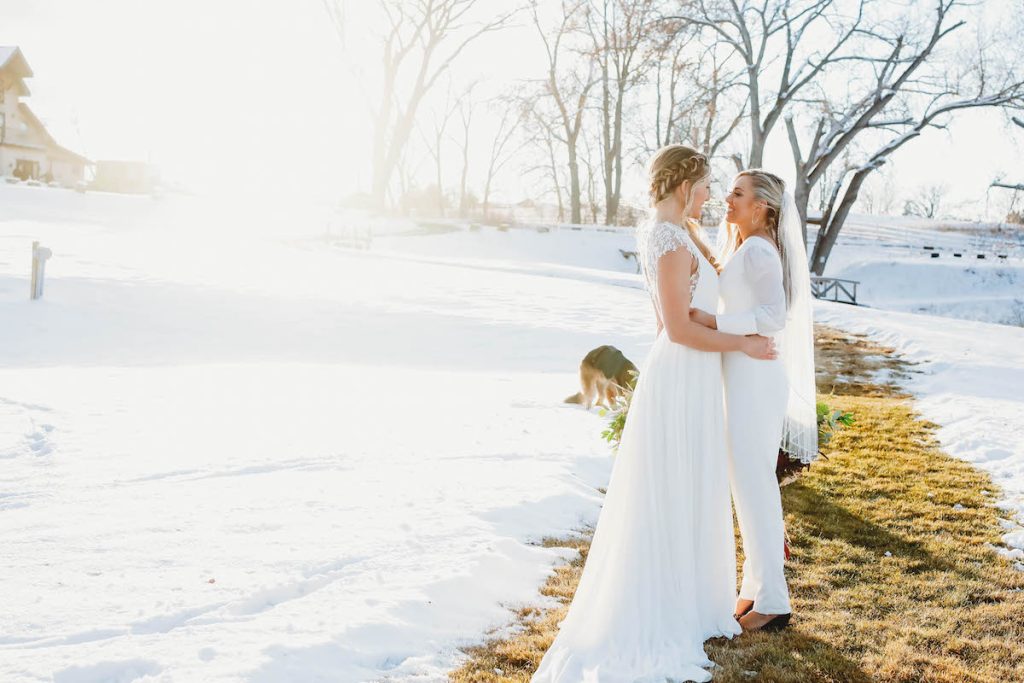 Two brides post for outdoor winter wedding 