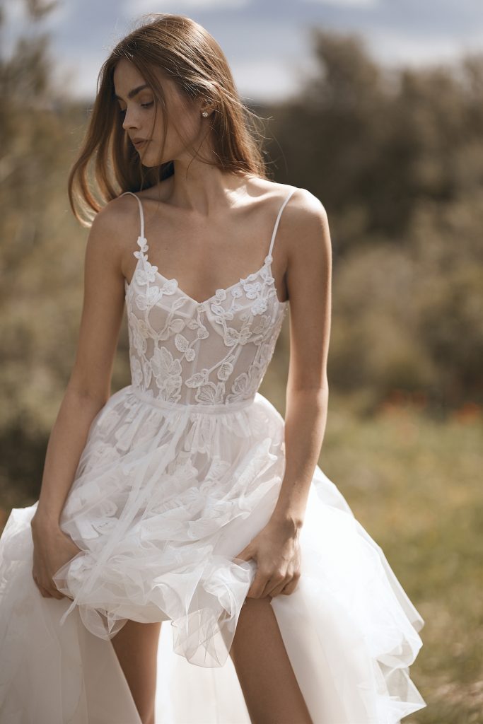 Thin strap white bridal gown with floral embroidery and exposed bodice