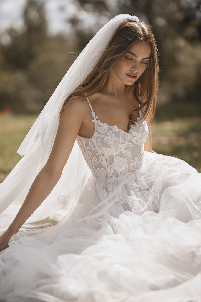 Thin strap white bridal gown with floral embroidery and exposed bodice