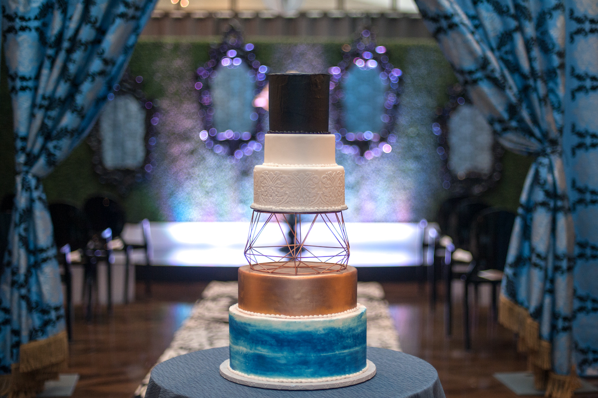 5-tier black, blue, and gold wedding cake